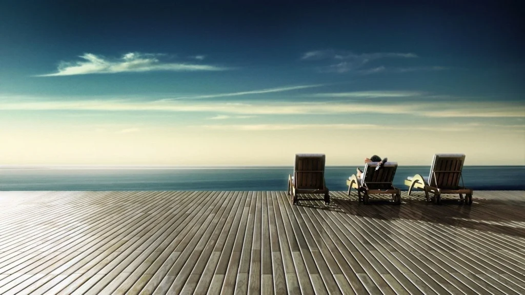 Relaxing chairs by the serene ocean.