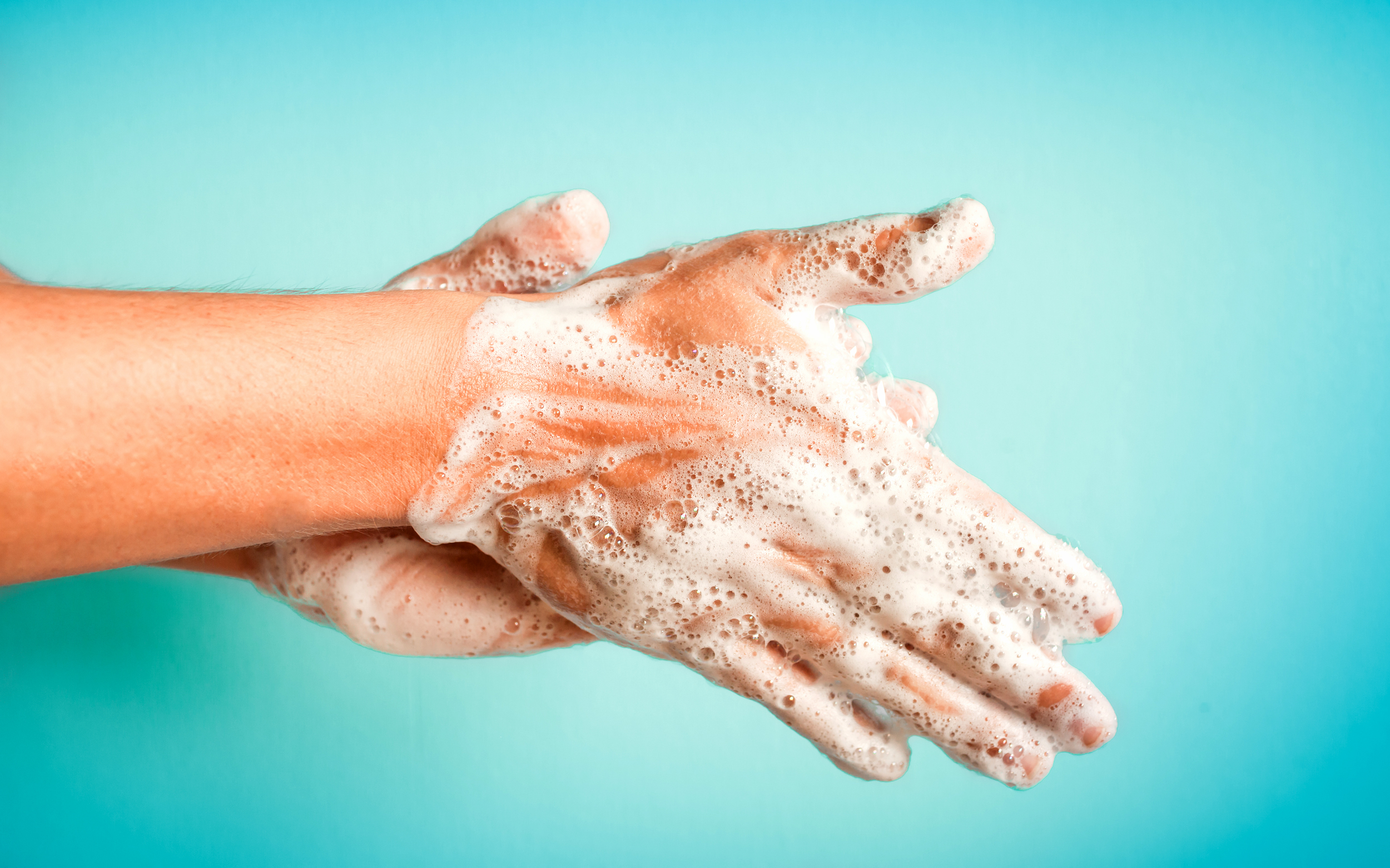 Closeup of person washing hands isolated. Cleanliness and body care concept.